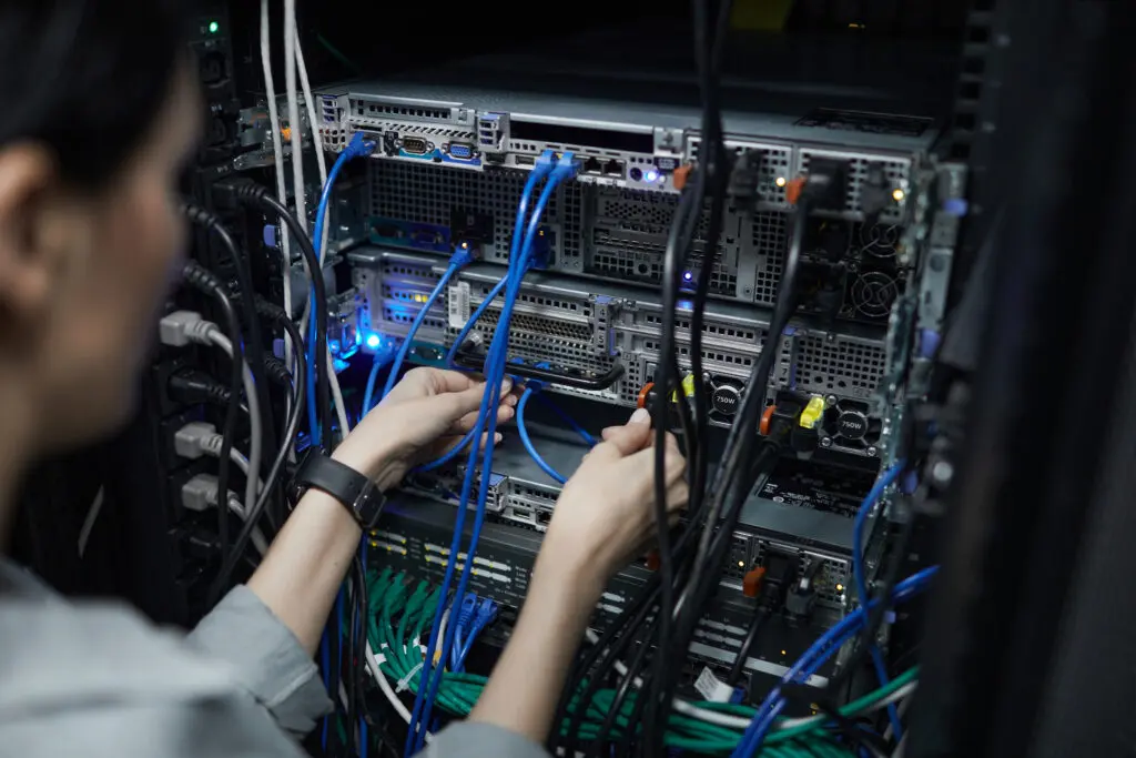 A person working on some wires in an office.